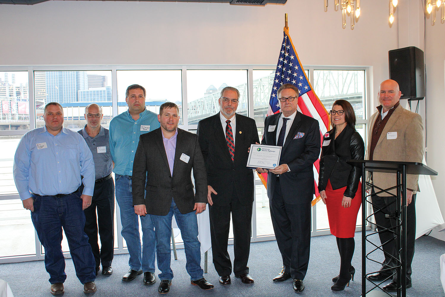 Tim Pickering (third from right) of the U.S. Maritime Administration presents a certificate designating a Nucor Steel’s hauling of steel coils by barge from Gallatin, Ky., to customers via the Port of Louisville as a marine highway project. The Ohio, Kentucky and Indiana Regional Council of Governments was the project sponor. Partners included Nucor Steel, the Central Ohio River Business Association and several ports in Kentucky, Indiana and Ohio. (Photo by Shelley Byrne)