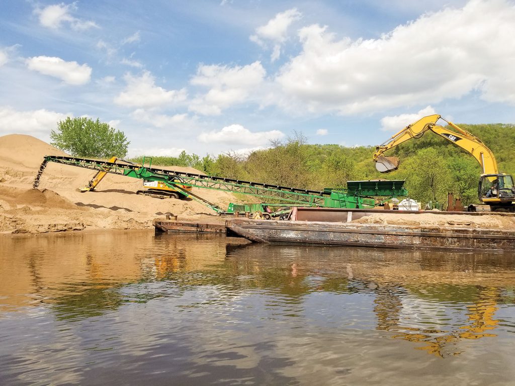 Dredged material unloading operation at a placement site in Pool 6. (Photo courtesy of St. Paul Engineer District)