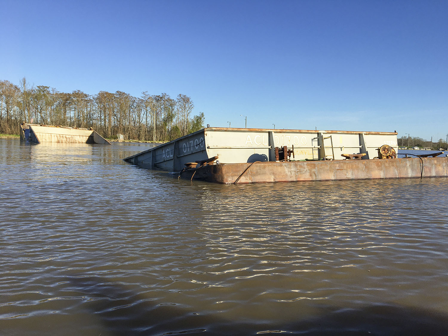 A barge in tow of the mv. Miss Odessa split in half and sank after the tow ran aground in the Gulf Intracoastal Waterway (Photo courtesy of U.S. Coast Guard)