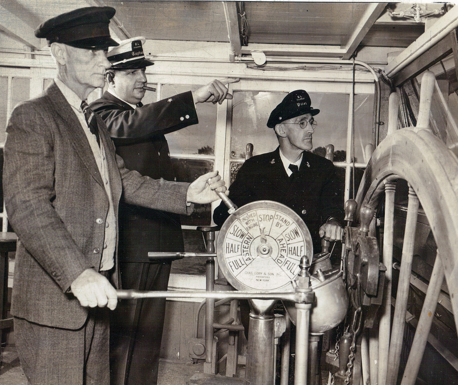 The pilothouse interior of the Str. Gordon C. Greene shows Capt. Billy Noland at the Gardner steering levers, as Capt. Tom Greene and Capt. Jesse Hughes look on in June of 1944. (Keith Norrington collection)