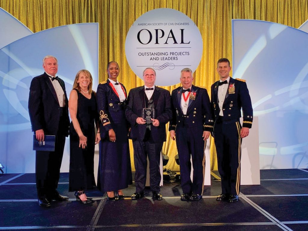 (Left to Right) Lloyd Caldwell, U.S. Army Corps of Engineers Director of Military Programs; Dr. Christine Altendorf, U.S. Army Corps of Engineers chief of engineering and construction; Louisville Engineer District Commander Col. Antoinette Gant; Olmsted Locks and Dam Project Manager Dewey Rissler; Chief of Engineers Lt. Gen. Todd Semonite; and Deputy Commanding General/Great Lakes and Ohio River Division Commander Maj. Gen. Robert Whittle accept a top 10 outstanding engineering award from the American Society of Civil Engineers for the Olmsted Locks and Dam project.