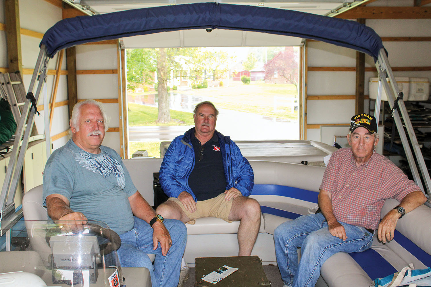 Friends Capt. Bob Cherry Jr., Sherman Jones and Sterling Edwards (left to right) prepare to take Cherry’s pontoon boat, My Cheri, down the entire 652-mile navigable length of the Tennessee River. (Photo by Shelley Byrne)