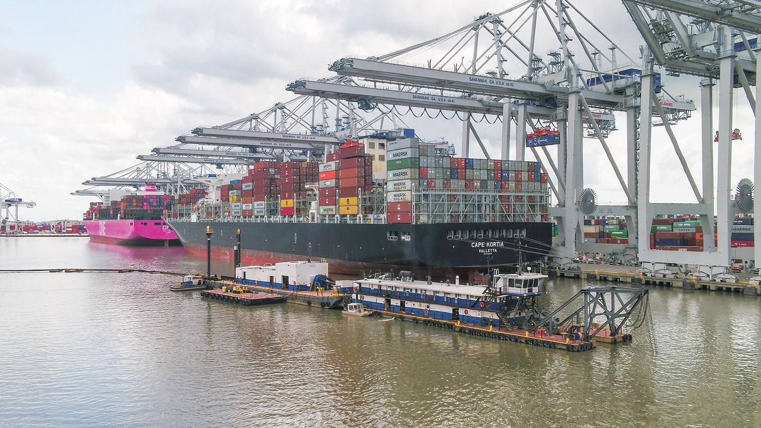 The Dredge Hampton Roads is shown maintaining a deepened channel in front of large cargo vessels docked at the Garden City Terminal of the Georgia Ports Authority May 28. (Photo courtesy of Georgia Ports Authority)