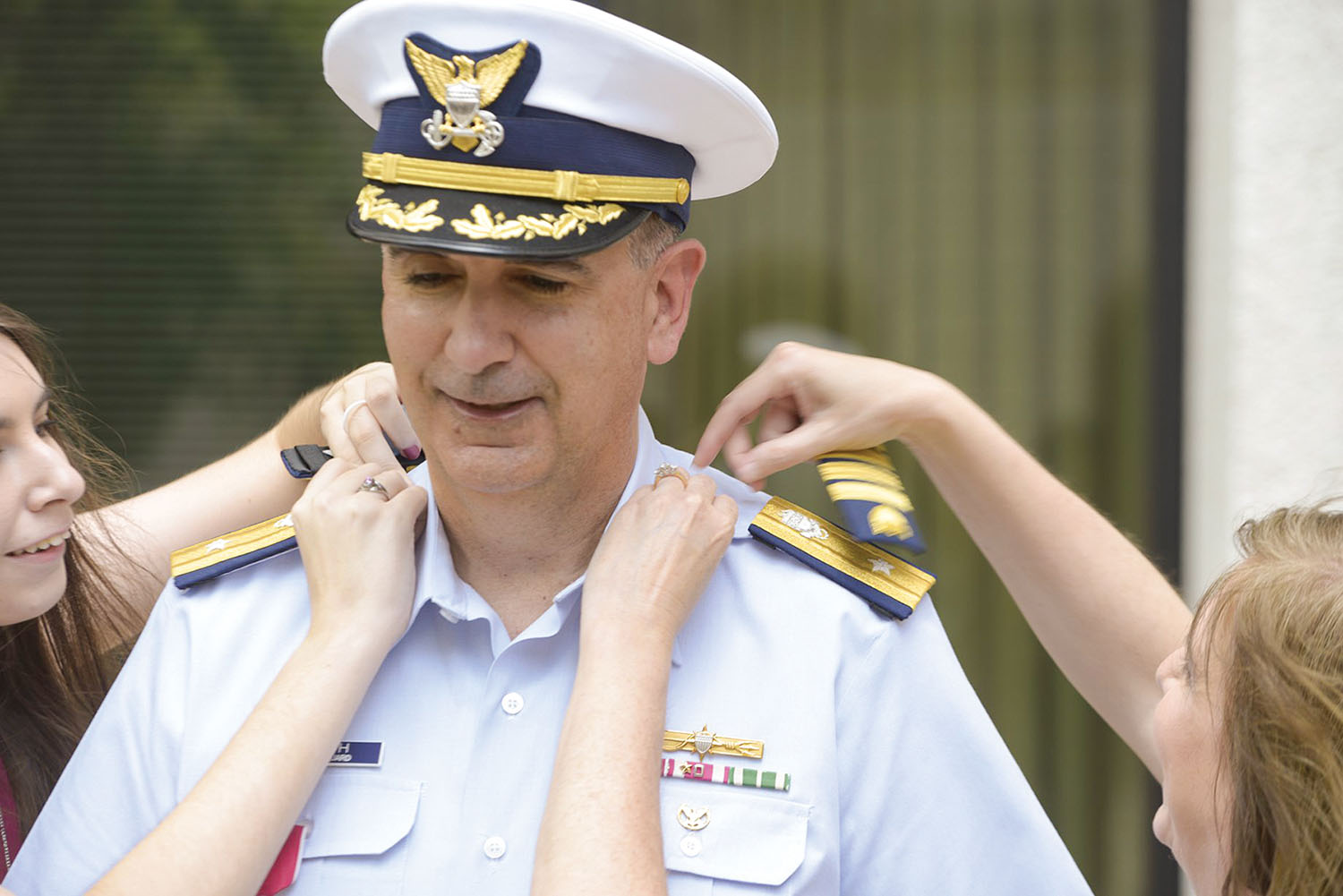 Rear Adm. Shannon Gilreath receives new shoulder boards from his daughter and wife during the May 22 frocking ceremony. (U.S. Coast Guard photo)