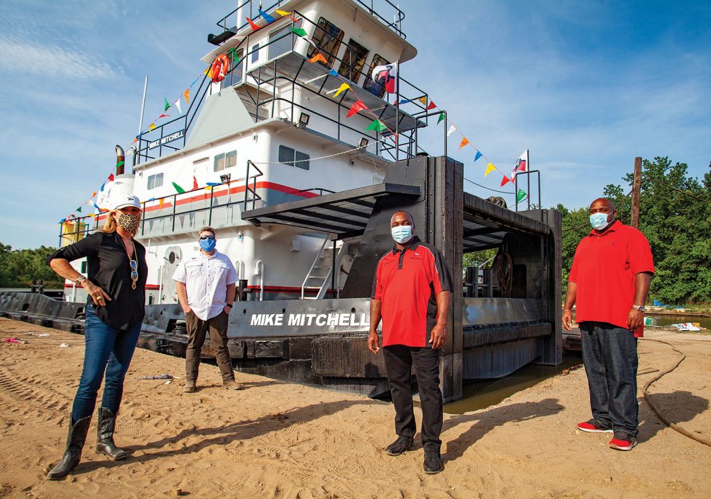 Mike Mitchell (center) and his brother, Joaquim, both Wood Towing captains, stand alongside Sarah Louise Wood Ham, CEO of Wood Resources, and Wood Towing General Manager Patrick McNeill at the May 12 christening. (Photo by Frank McCormack)