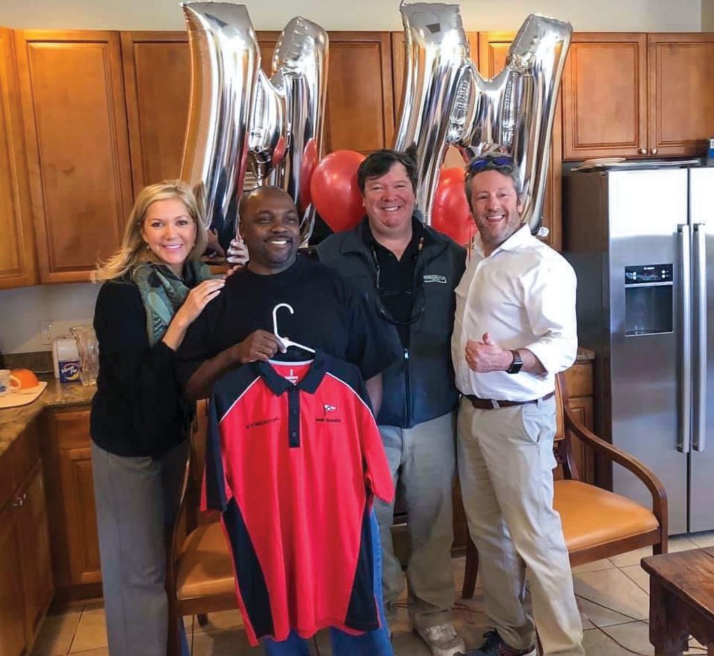 Mike Mitchell, center-left, stands alongside members of the Wood family, including, from left, Sarah Louise Wood Ham, Donald Wood Jr. and Pearce Wood on March 6, the day he learned the newest Wood Towing vessel would be named the mv. Mike Mitchell. (Photo courtesy of Wood Towing)