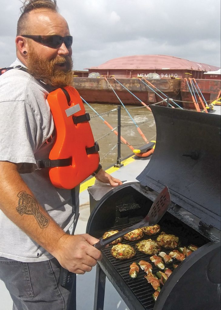 Matt Brewer grills stuffed mushrooms and jalapenos.