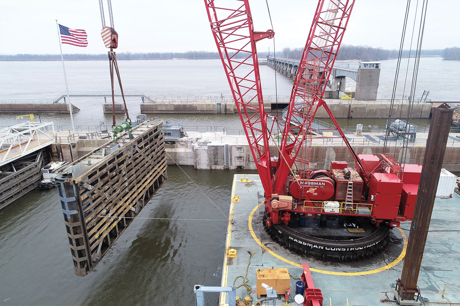 Massman Construction’s barge-mounted ringer crane moves miter gate as part of anchorage replacement project. (Photo courtey of Massman Construction)