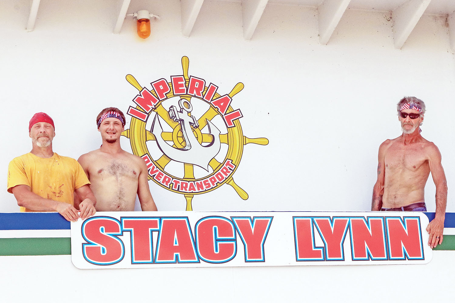 Terry Mullins, T. J. Mullins and “Punkin” Owings hold new name board to be installed. (Photo by Jeff L. Yates)