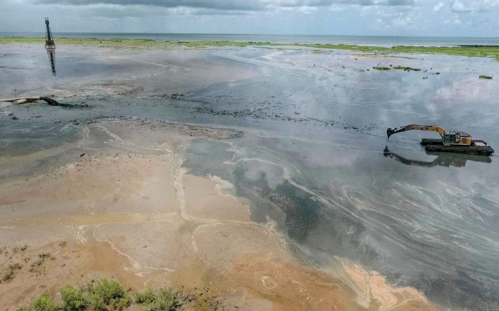 An excavator directs newly-dredged material at a beneficial use disposal area near Southwest Pass. (Photo courtesy of Big River Coalition/P.J. Hahn)