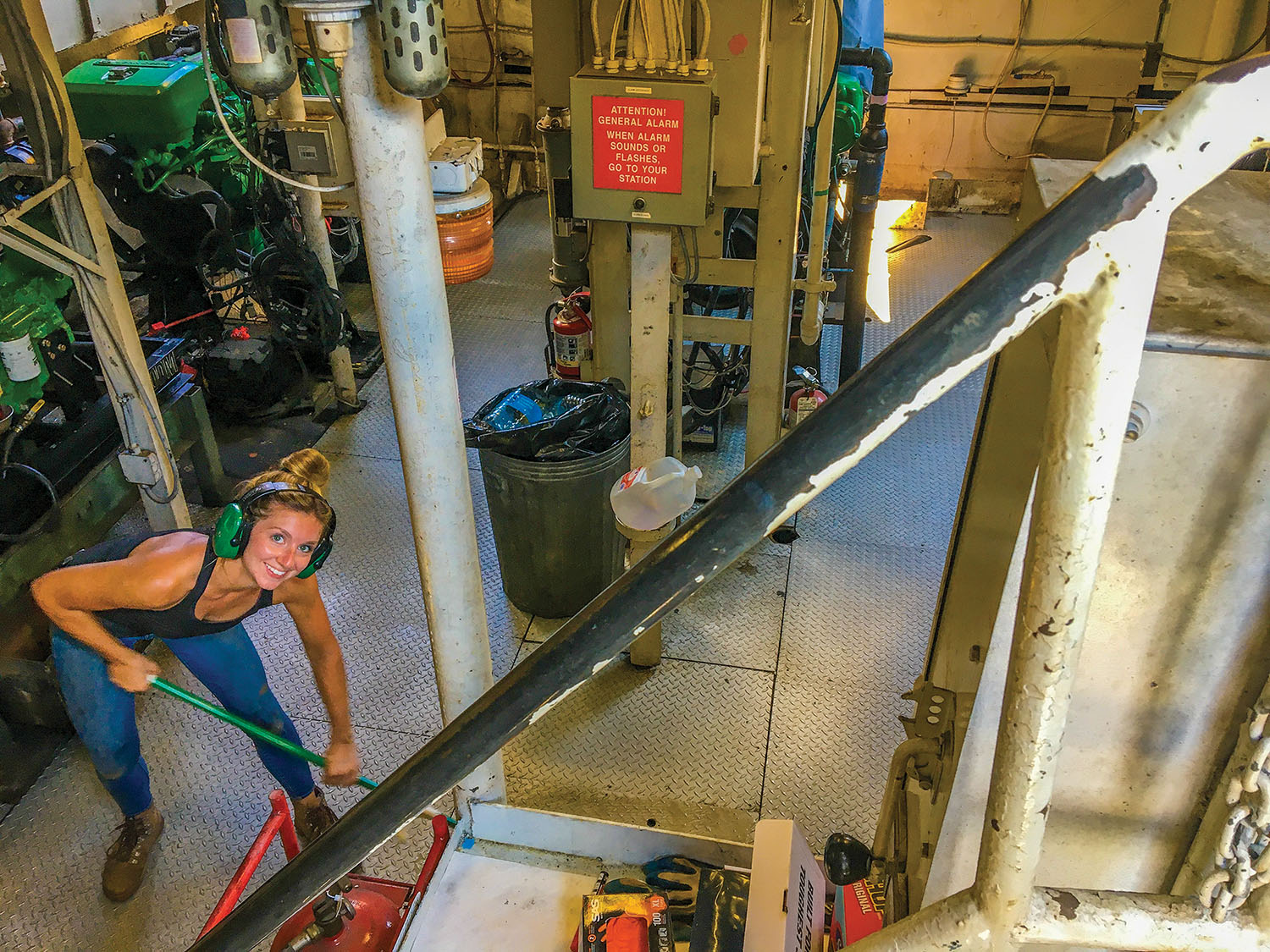 Leah Cafarelli, program director for Living Land and Waters, helps clean up the engineroom of the River Cleanup II. (Photo courtesy of Living Lands and Waters)