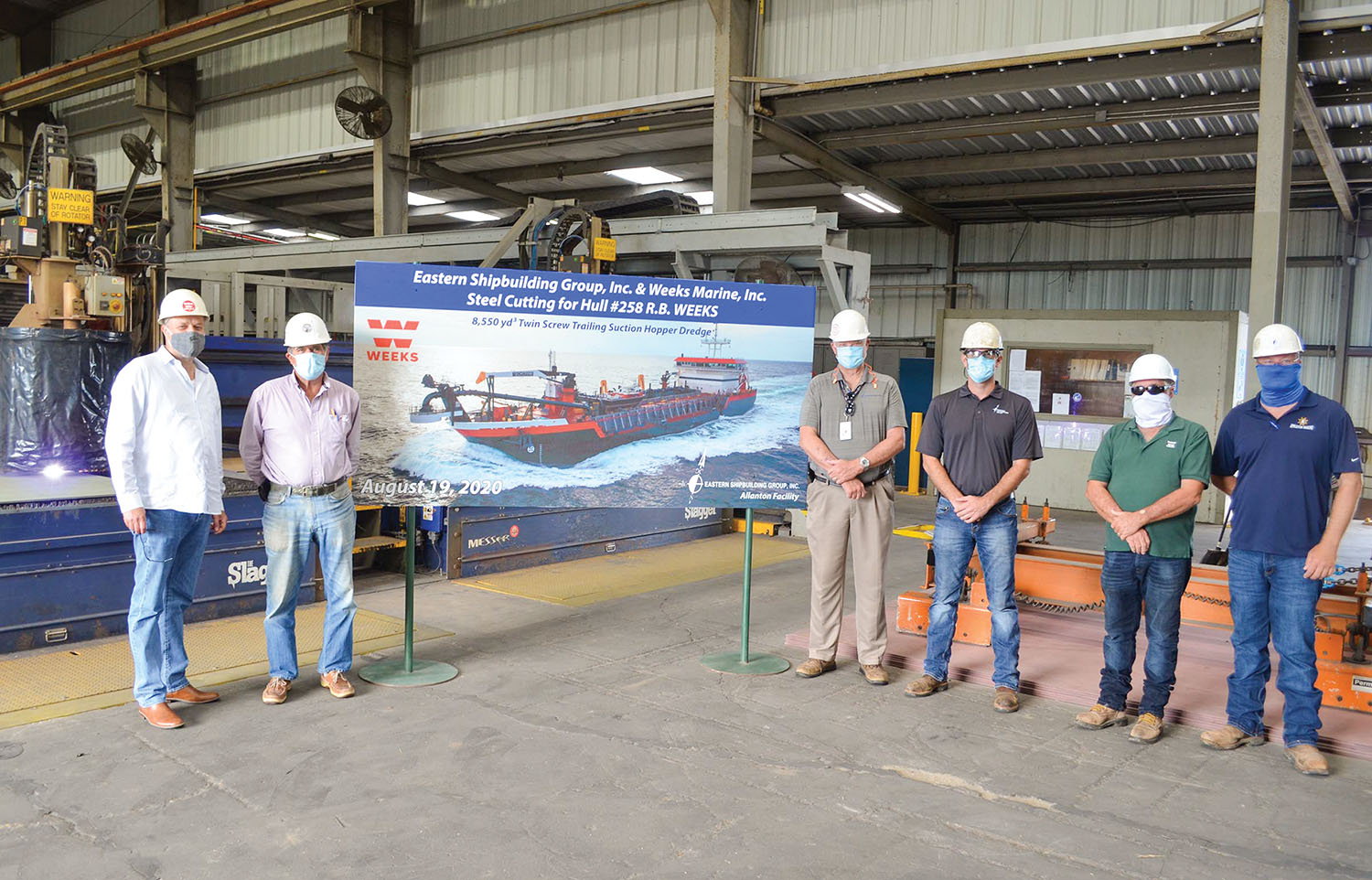 Hans Bloomberg of Weeks Marine Inc., left, stands with Eastern Shipbuilding Group representatives Brian D’Isernia, Kenneth Munroe, Jamie Keel, Benny Bramblette and Bob Babb at a ceremony celebrating the steel cutting for the R.B. Weeks.