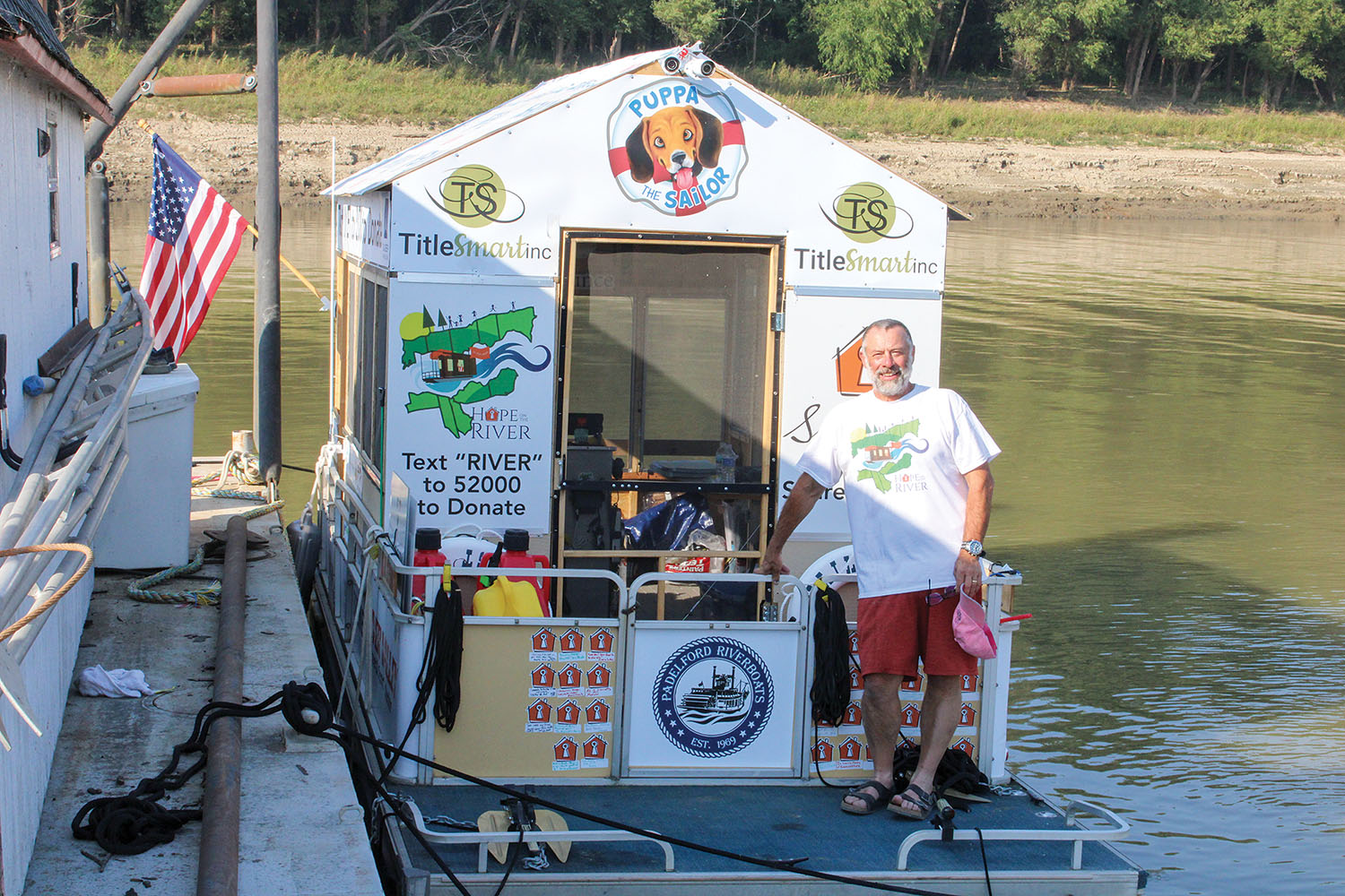 Erich Mische stands on the deck of his S.S. Hail Mary on October 7 in Hickman, Ky. He is traveling by pontoon boat down the Mississippi River to raise awareness for Spare Key, the non-profit he heads that provides help for bills after serious injuries and critical illnesses. (photo courtesy of Hope On The River)