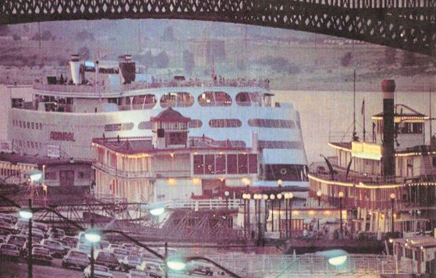 Caption for top photo: Fifty years ago on the St. Louis levee, the excursion steamboat Admiral boards passengers for an evening cruise while the permanently moored Goldenrod Showboat and Str. Becky Thatcher light up the waterfront. (Keith Norrington collection)