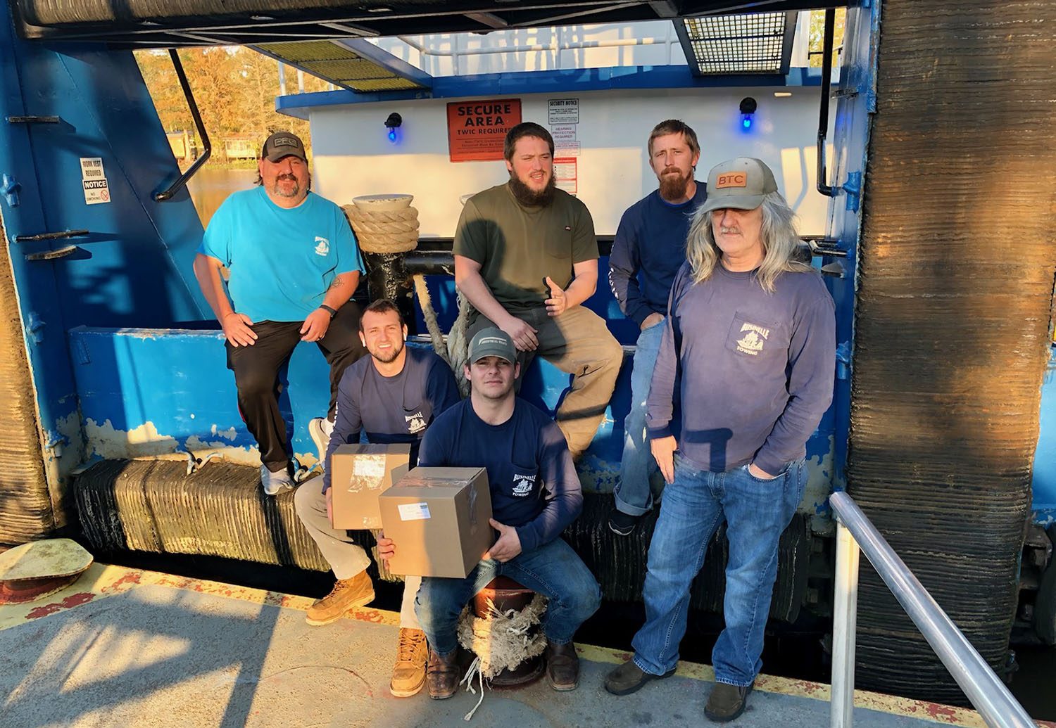 Crews of the Businelle Towing mvs. Kathleen and Theresa B, with gift boxes from the Seamen’s Church Institute’s Christmas at Sea Program: from left: Scott Revelle, Hunter Collins, Vernon Bolds, Ryan Vaughn, Neal Smith and Ralph Smith. (Photo courtesy of Seamen's Church Institute)