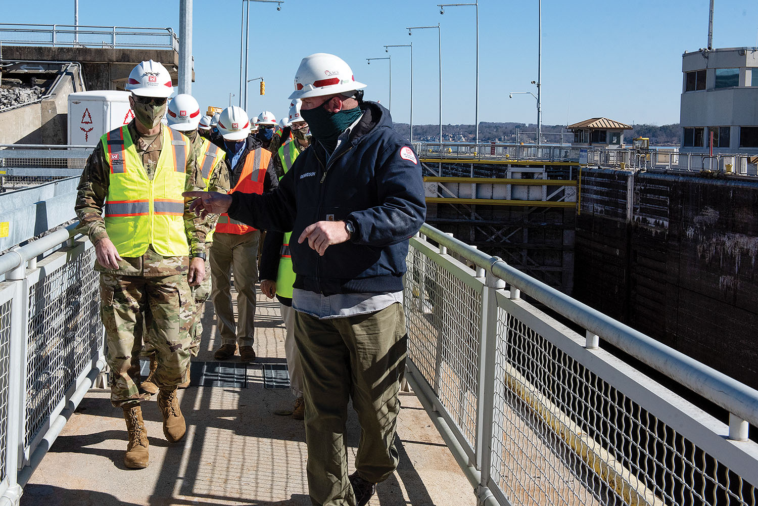 Cory Richardson, Chickamauga lockmaster, leads Lt. Gen. Scott Spellmon, 55th chief of engineers, on a tour of Chickamauga Lock on the Tennessee River on February 3. The lock has experienced structural problems and is not large enough to accommodate modern tow sizes, resulting in longer than normal tow-processing times. The Corps is building a larger replacement lock at the Tennessee Valley Authority project. (photo by Lee Roberts/Nashville Engineer District)