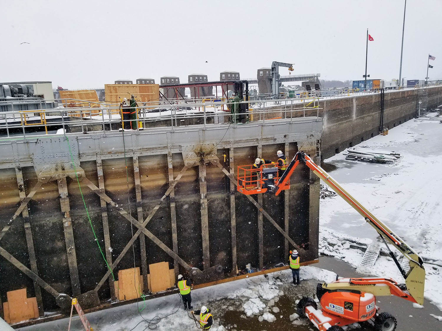 Lock and Dam 4 in Alma, Wis., is dewatered in order to conduct maintenance. Major winter maintenance like this occurs about every 20 years and includes concrete repairs, sandblasting and repainting the miter gates and updating the bubbler system used to prevent ice buildup within the lock chamber. Due to the use of heavy equipment and safety requirements, the parking lot and pedestrian bridge are closed during the repairs. The $3.5 million maintenance project is scheduled to be completed mid-March, ahead of the 2021 navigation season. (Photo courtesy of St. Paul Engineer District)