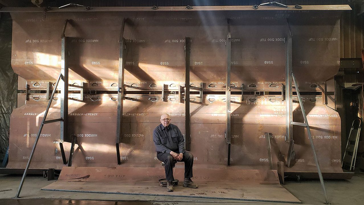 Ray Bergeron sits in front of new 24- by 23-foot (when fully open) clamshell being built for the Houston area.
