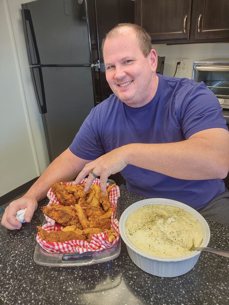 Pilot Brandon Lehr enjoys Sunday’s fried chicken.