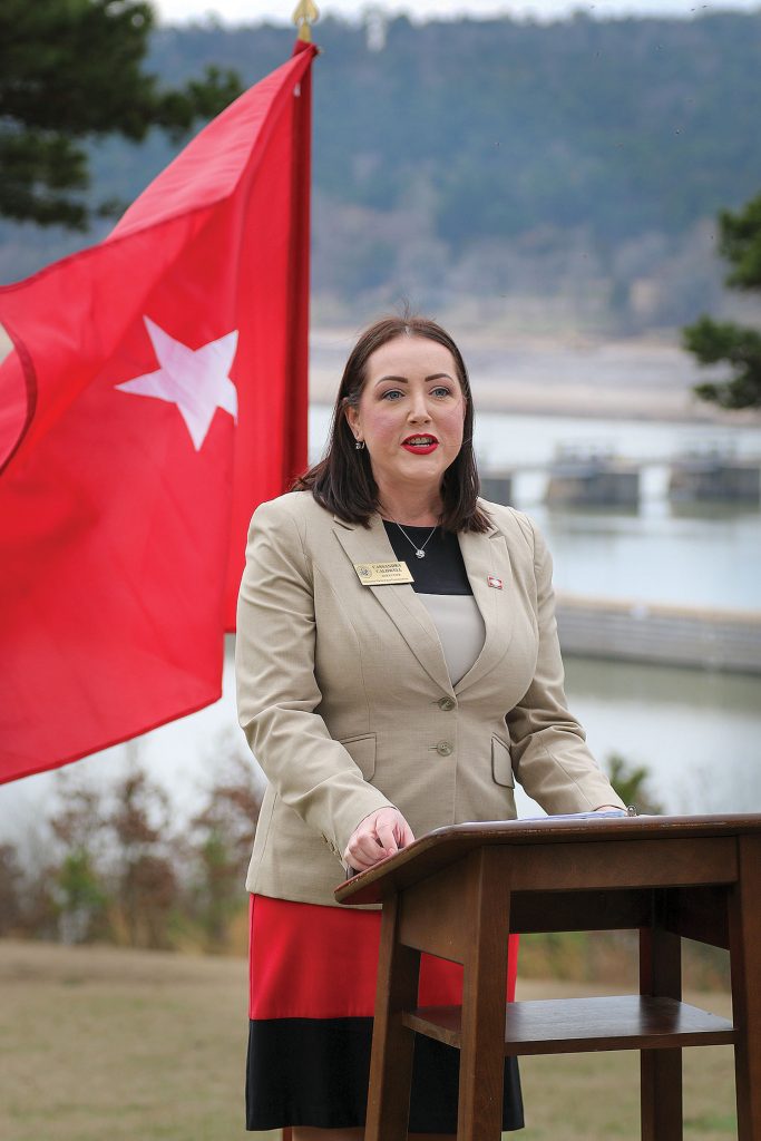 Cassandra Caldwell, director of the Arkansas Waterways Commission, speaks with media, stakeholders and partners at an overlook on the McClellan-Kerr Arkansas River Navigation System.