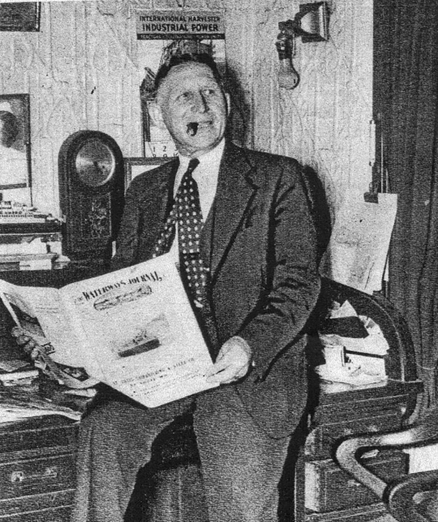 Capt. Menke reads The Waterways Journal in his office aboard the showboat. (Keith Norrington collection)