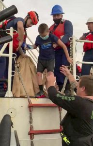 One of the family members transfers from the Coast Guard Cutter Sea Dragon to the sheriff's office vessel, prior to heading back ashore.  (Photo courtesy of Nassau County Sheriff's Office)