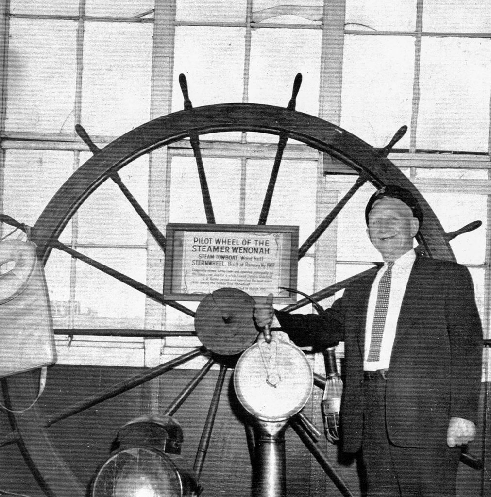 Capt. J.W. Menke with the pilotwheel of the Wenonah aboard the Goldenrod Showboat at St. Louis. (Keith Norrington collection)