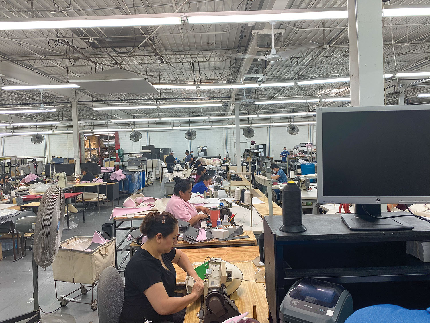 A line of sewing operators sews covers at Llebroc Industries. (Photo courtesy of Llebroc Industries)