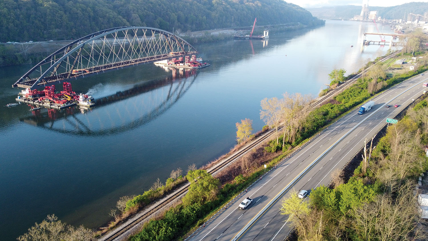 Towboats from Excell Marine move the main span of the new bridge between Wellsburg, W.Va., and Brilliant, Ohio, down the Ohio River on barges April 26. (Photo courtesy of the Ohio Department of Transportation)