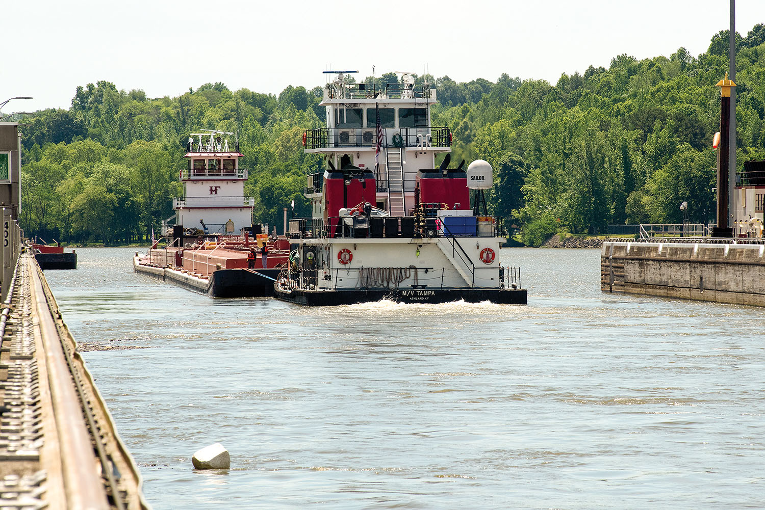 The mv. Tampa out of Ashland, Ky, and mv. Jess A. Mollineaux out of Nashville, Tenn., guide Marathon Petroleum Company fuel barges May 21 out of Cheatham Lock in Ashland City, headed to terminals in Nashville. The Nashville Engineer District worked with the fuel industry and Regional Rivers Repair Fleet, which is performing maintenance at the lock, to schedule openings to accommodate deliveries of fuel to middle Tennessee. Each barge carries around 28,000 barrels of fuel. (Photo by Lee Roberts, courtesy of Nashville Engineer District)