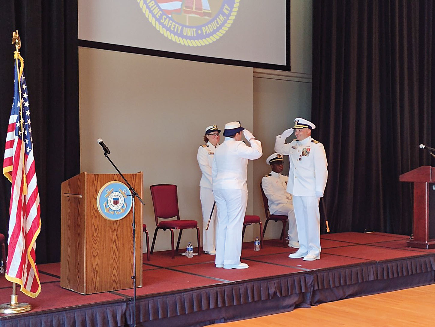 Caption for photo: Cmdr. Jennifer G. Andrew and Cmdr. Luis Carmona salute during a June 4 change of command ceremony. The ceremony featured remarks from both, along with awards and a few surprises. (Photo by Shelley Byrne)