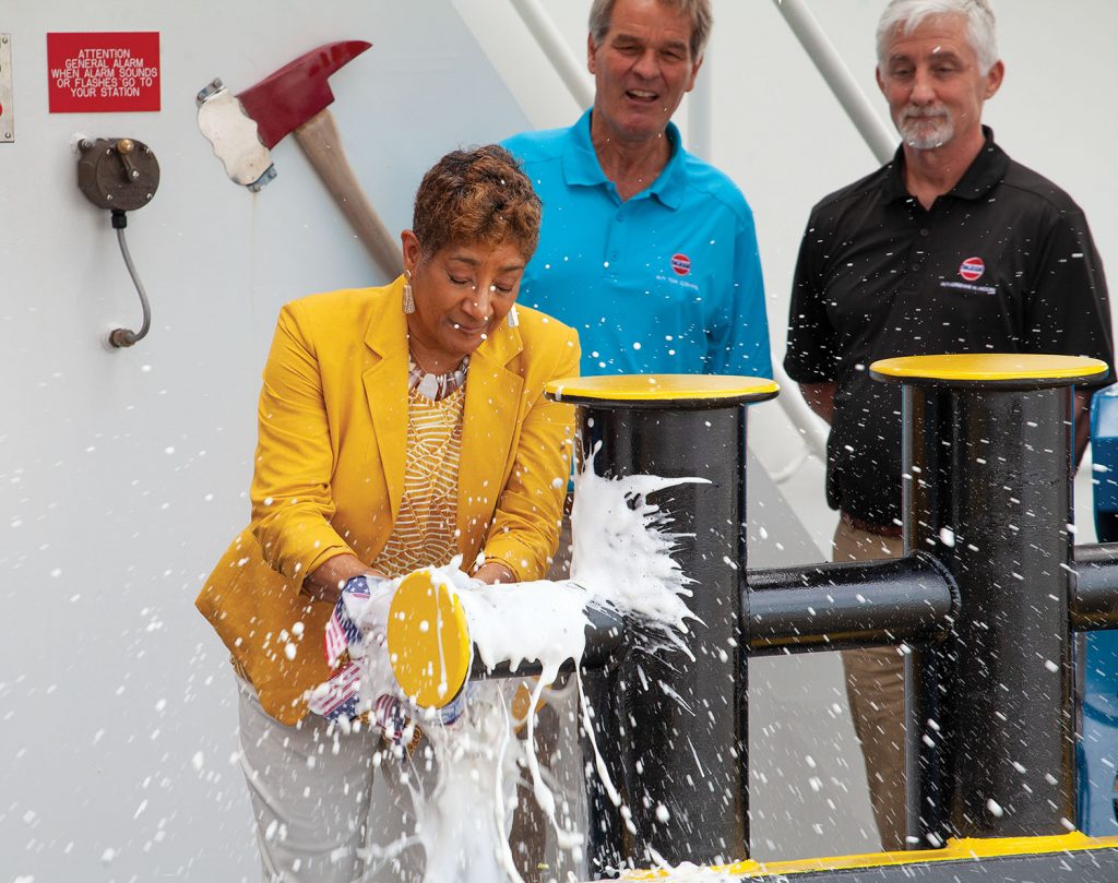 Adrienne Moore christens towboat named in her honor while Orrin Ingram and Dave O’Loughlin look on. (Photo by Frank McCormack)