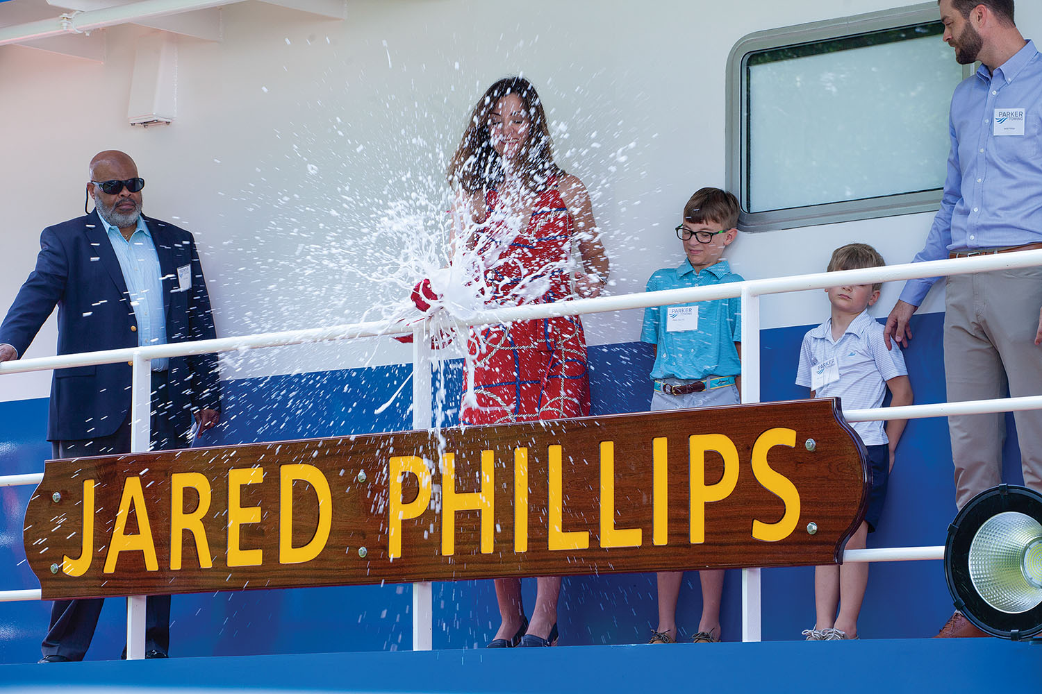 Alison Phillips smashes a bottle of champagne to christen the mv. Jared Phillips. (Frank McCormack photo)