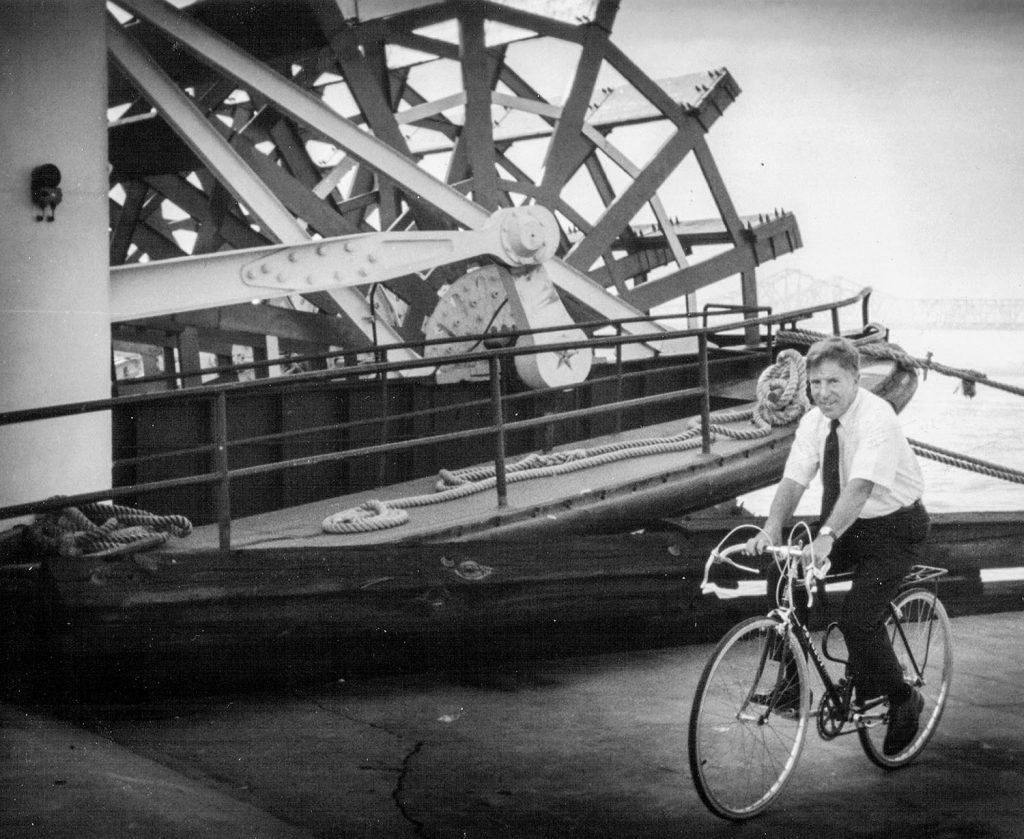 Capt. Doc Hawley travels by bicycle from his French Quarter home to the steamboat Natchez in 1993. (Keith Norrington collection)