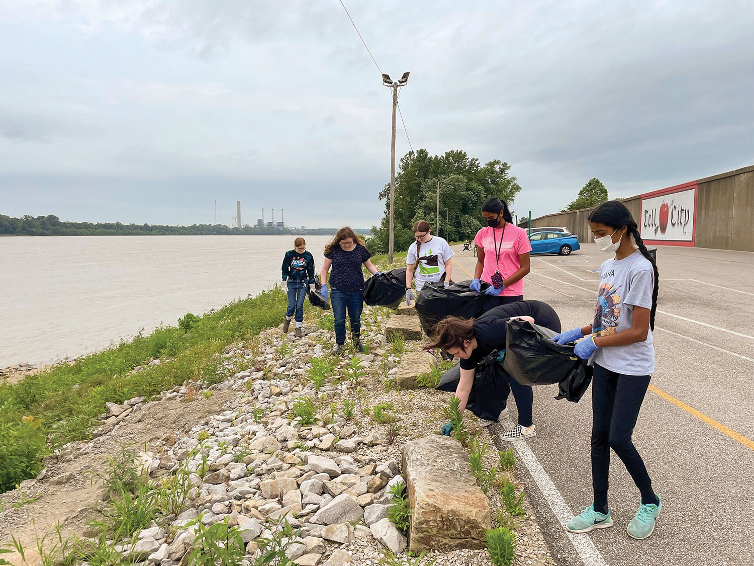 Perry County, Ind., volunteers, led by coordinator Ceceilia Mundy, pick up trash along the shore of the Ohio River in a “mini-sweep” event earlier this year. (Photo courtesy Ohio River Valley Sanitation Commission)