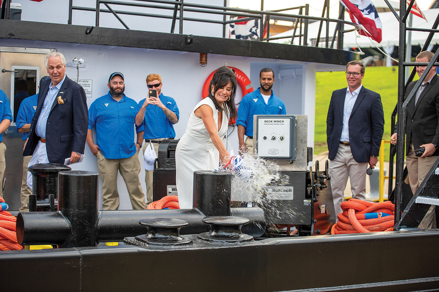 Marci Gale Casselhoff christens her namesake vessel with a bottle of champagne. (Photo by Fisher Fotos)