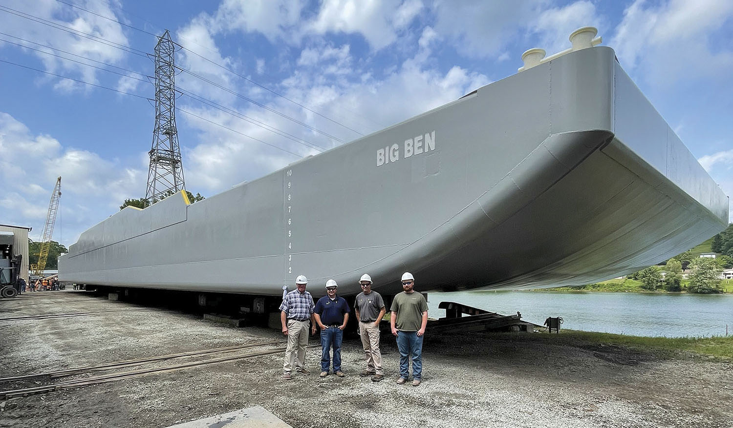 Before the barge launch are, from left, Rodney Linker, Cody Shields, Leo Dufrenne and Chase White. (Photo courtesy of Heartland Fabrication)