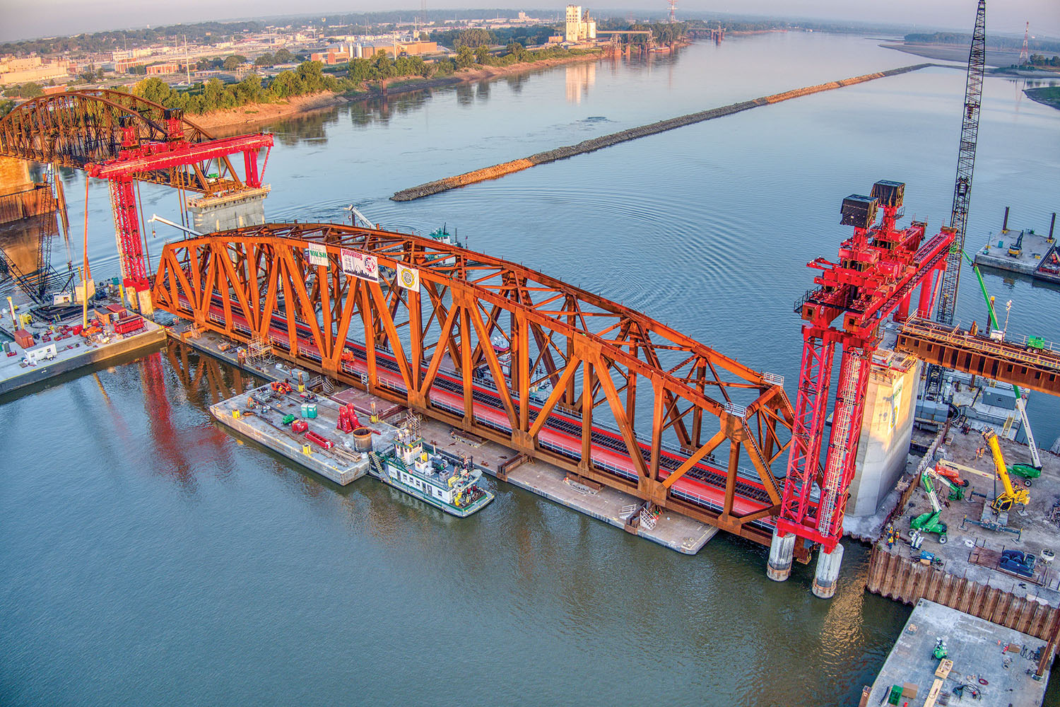 The first of three trusses is slowly raised into position to be placed on the Merchants Bridge on the Mississippi River in downtown St. Louis. (Photo courtesy of Walsh Construction and Trey Cambern Photography)