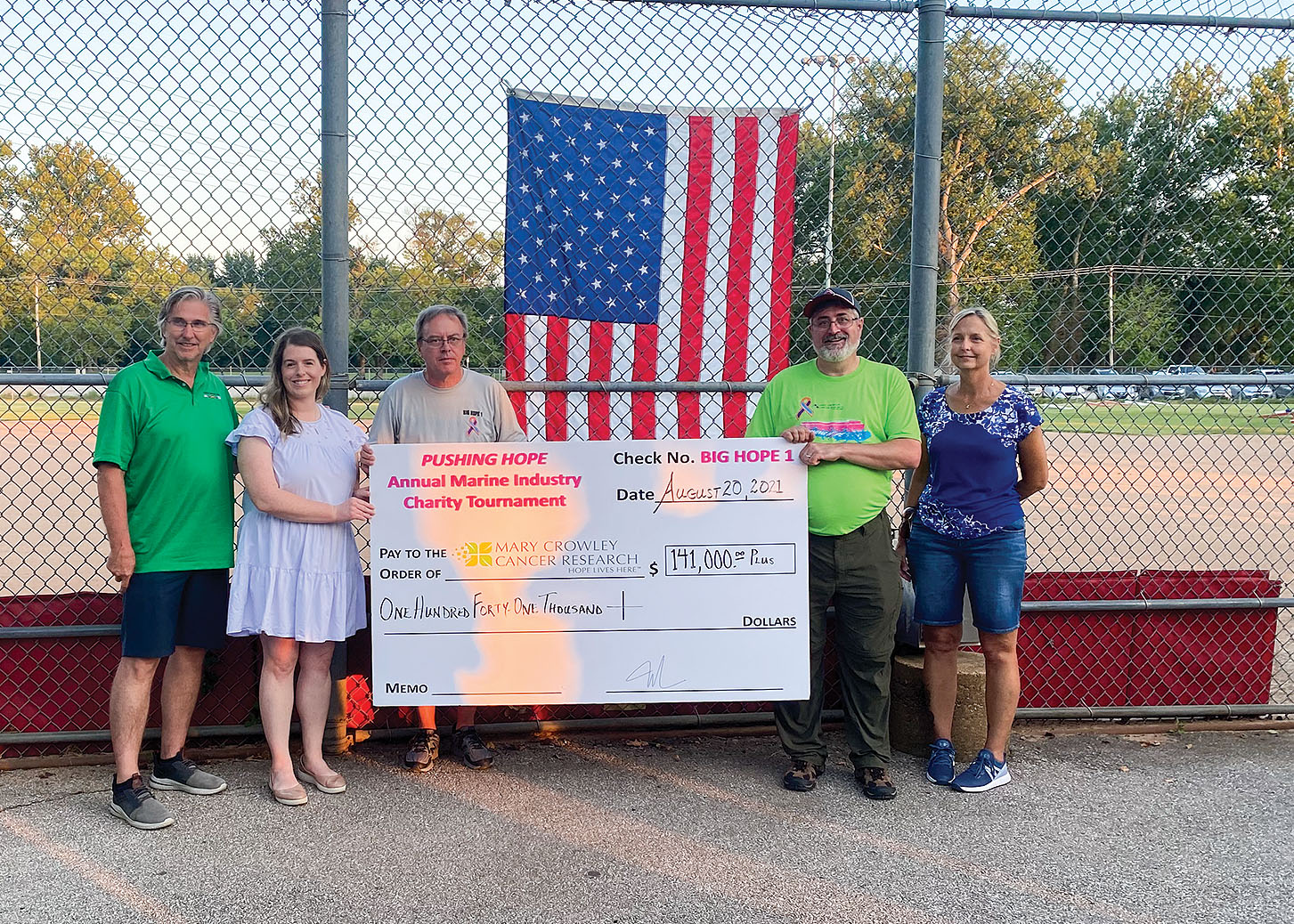 From left, Mark Mestemacher, Jenny Dunne and Mark Fletcher of Ceres Consulting present a ceremonial check to William Bogie and Leslie Sprenger of Mary Crowley Cancer Research.