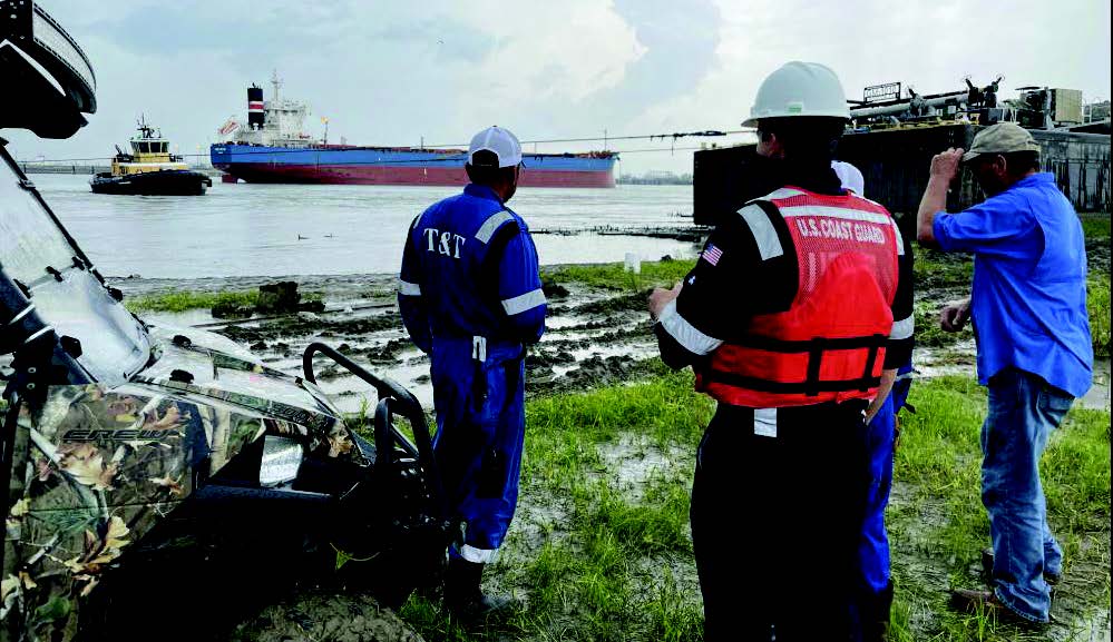 —photo courtesy of the U.S. Coast Guard The Coast Guard Salvage Engineering Response Team (SERT) provides technical analysis and assistance to salvors attempting to free grounded Genesis Marine barges on the Bonnet Carre Spillway September 6, 2021. The SERT worked alongside the salvage master and representatives from T&T Salvage and Genesis Marine to free the barges.
