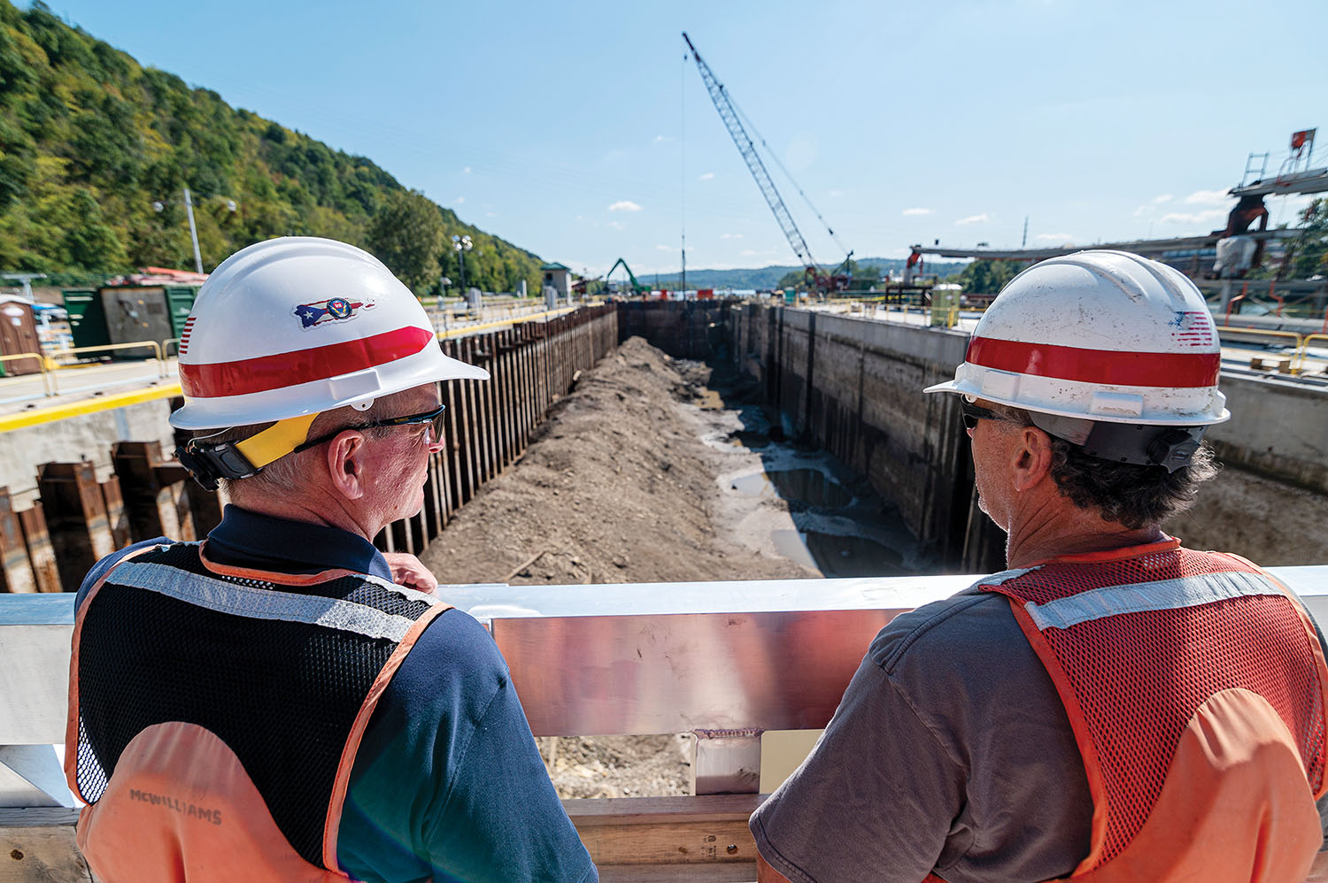 Kirk McWilliams and Shawn Soltis, resident and field engineers for the Pittsburgh Engineer District, stand over the construction project at Charleroi Locks and Dam on the lower Monongahela River in Pennsylvania on September 30. The district recently finished building the new lock chamber walls and has emptied it of approximately 20 million gallons of water to allow contractors to begin adding the mechanical inner works of the chamber. (Photo by Michel Sauret/Pittsburgh Engineer District)