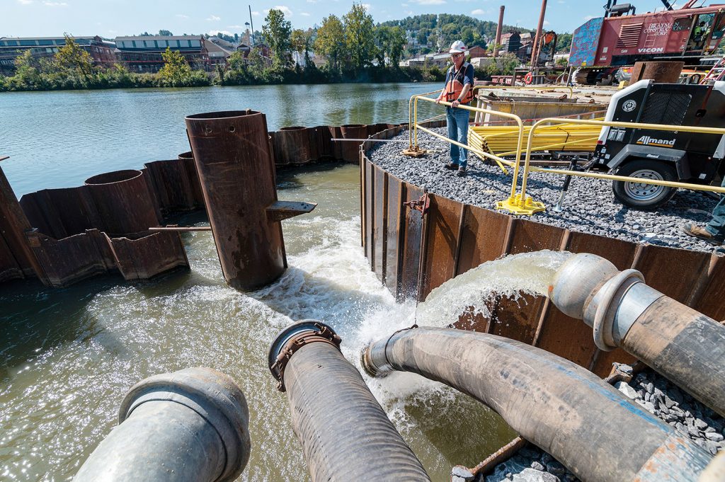 Water flows from the newly constructed riverside lock chamber as part of the dewatering process. (Photo by Michel Sauret/Pittsburgh Engineer District)