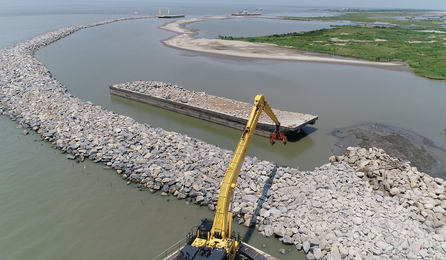 The West Grand Terre Beach Nourishment and Stabilization Project is using nearly 2.5 million cubic yards of dredged sand and close to 50,000 tons of armor stone to restore the shoreline of West Grand Terre Island. The beaches, dunes and marshes protect communities between New Orleans’ west bank and Bayou Lafourche. (Photo courtesy of Daulton Barge Leasing, Sales & Management)