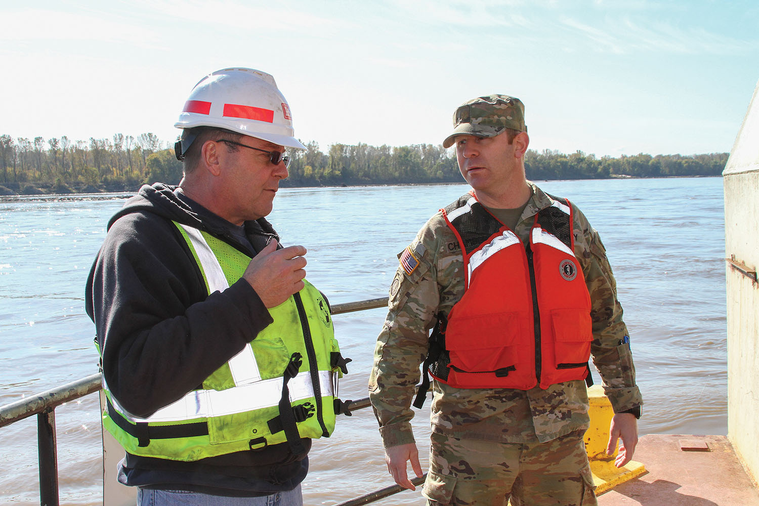 Jake Bernhardt, chief of physical support for the Goetz, explains the operations of the dredge to Maj. John Chambers, deputy commander for the Kansas City District, on the Missouri River near St. Charles, Mo.