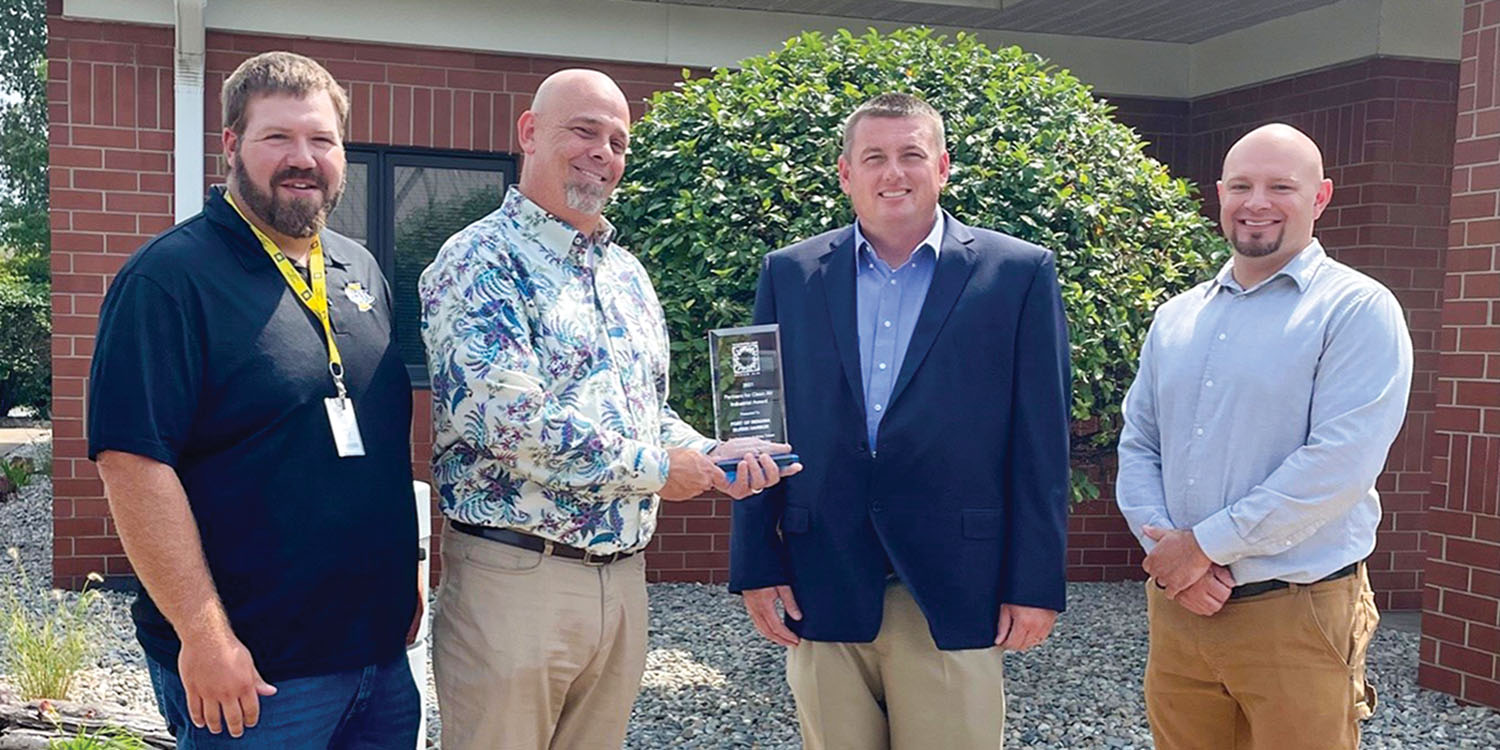 Charles Breitenfeldt, Partners for Clean Air coordinator, and Scott Nelson, board member for Partners for Clean Air, present Ryan McCoy, Burns Harbor port director, and Nick Harper, operations manager, with the Industrial Award. Photo courtesy of Ports of Indiana)
