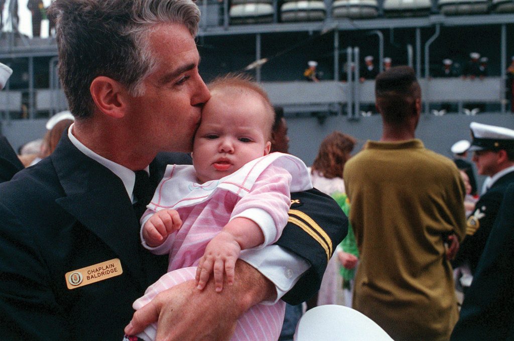 Reunited with infant daughter Grace in March 1991 after Gulf War deployment, on board the USS Thomas S. Gates in Norfolk, Va. (Photo courtesy of Kempton Baldridge)