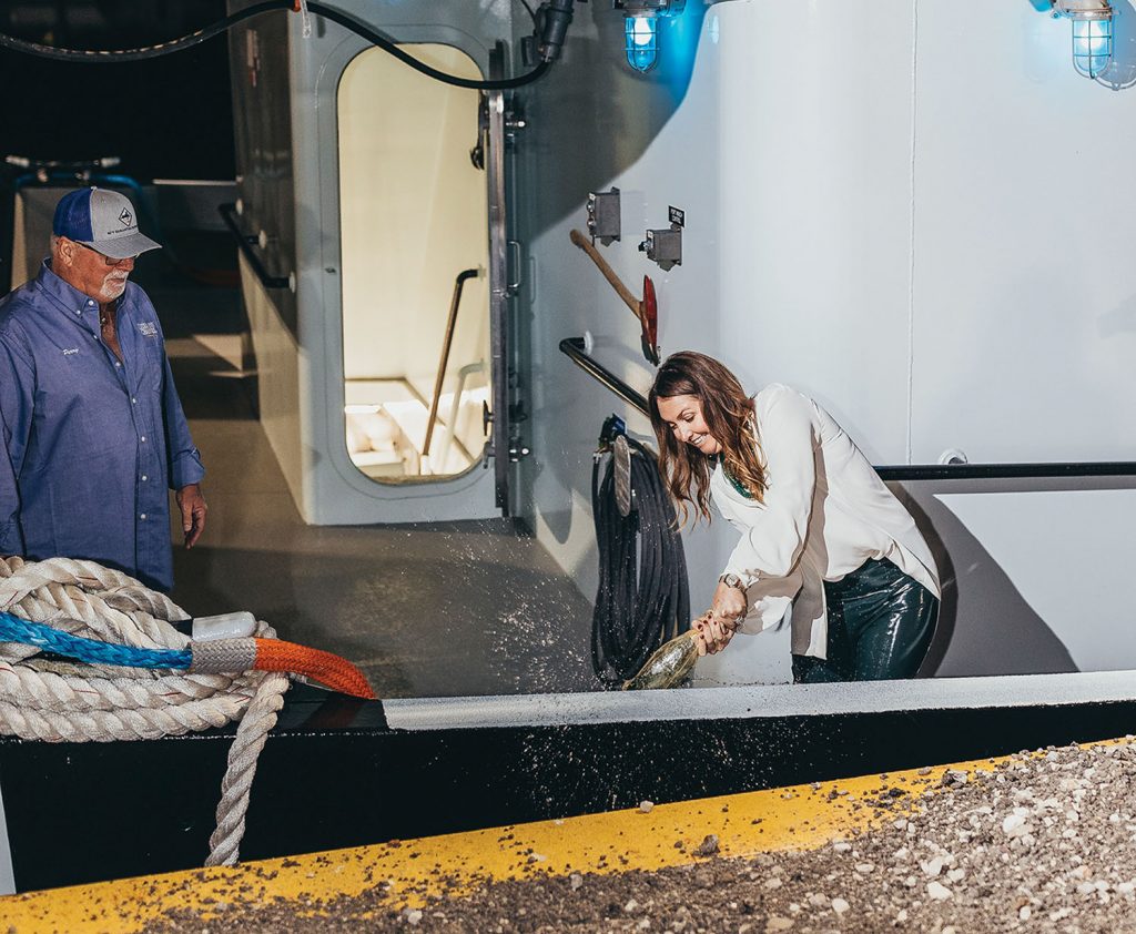 Samantha Gates christens the mv. Samantha Trueheart while Capt. Perry Russo looks on. (Photo by Lillian Jean Photography)