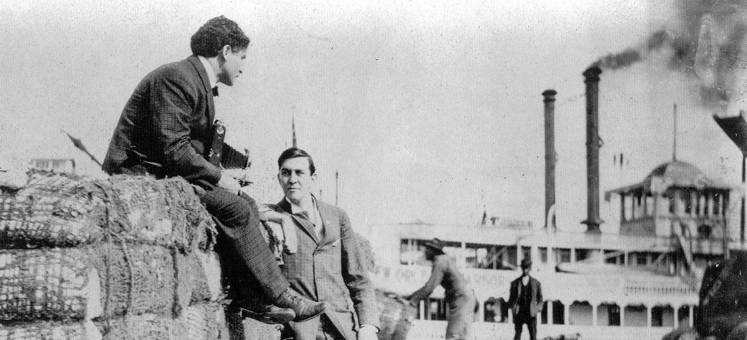 Harry Houdini sitting atop a cotton bale at the foot of Canal Street in New Orleans. The steamboat J.S. is at the wharf. (Keith Norrington collection)