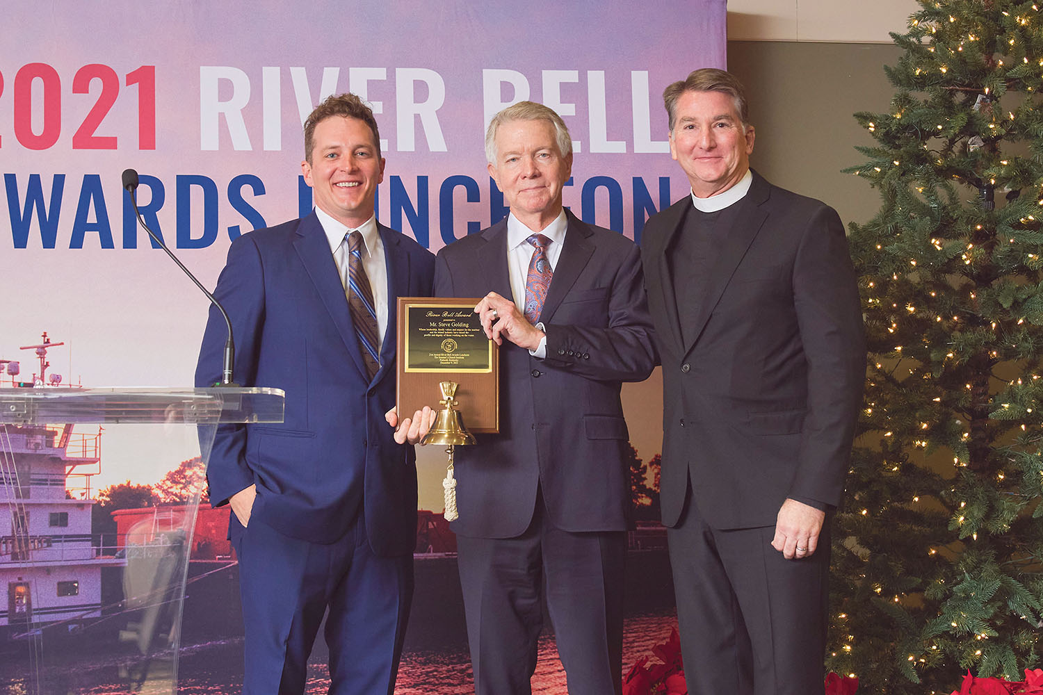 Austin Golding, left, and Rev. Mark Nestlehutt flank Steve Golding, chairman of Golding Barge Line, who received the River Bell Award at the 21st annual River Bell Awards Luncheon in Paducah, Ky., December 9. (Photo courtesy of Seamen's Church Institute)