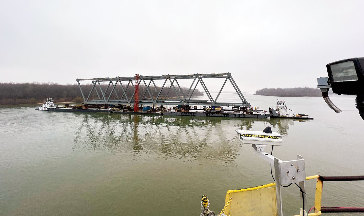 The steel truss of the new $63.6 million Cumberland River bridge rotates in the Tennessee River just off-shore from the Paducah-McCracken County Riverport Authority. The truss must be turned six times during construction. It will then be floated to Smithland, Ky., for installation. (Photo by Scott Swamback/American Bridge Company)